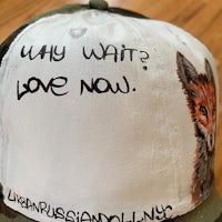 a hat with a painting of a fox on it